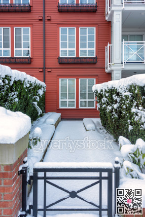 Pathway to residential building covered with snow