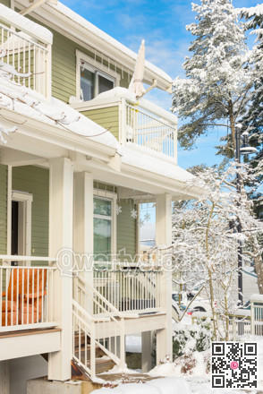 Residential townhouses and high-rise building on bright winter day