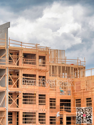 Apartment building under construction on cloudy sky background