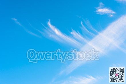 Feather clouds on deep blue sky background